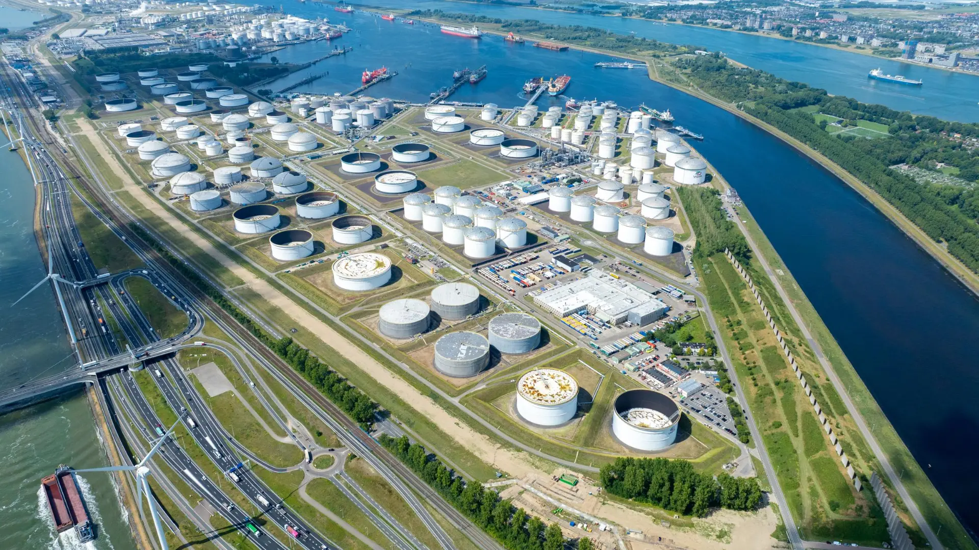 Aerial view of petroleum storage tanks beside a river
